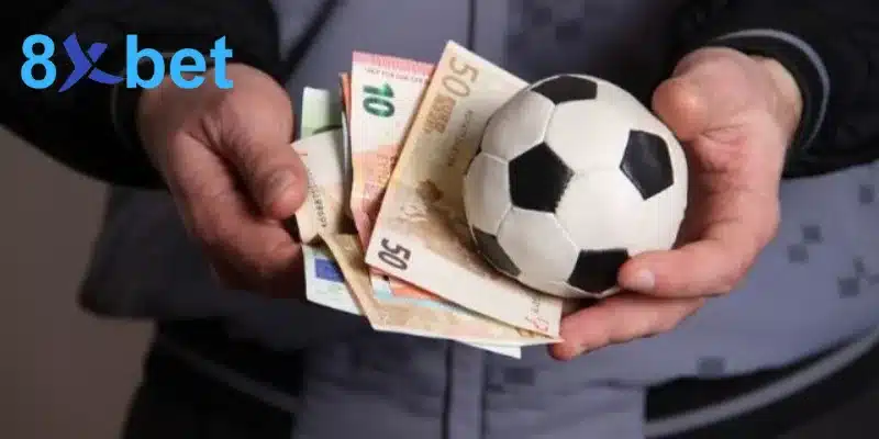 Hai tay cầm tiền euro và quả bóng nhỏ
